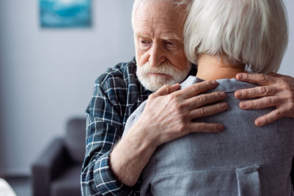 elderly couple hugging