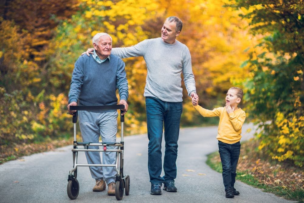 Three generations of men in a family walking together outdoors